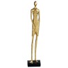 Statuette of a woman in an evening dress, in golden resin